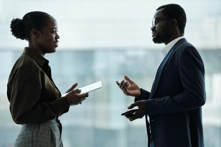 two-young-african-american-employees-formalwear-having-discussion_274679-39855